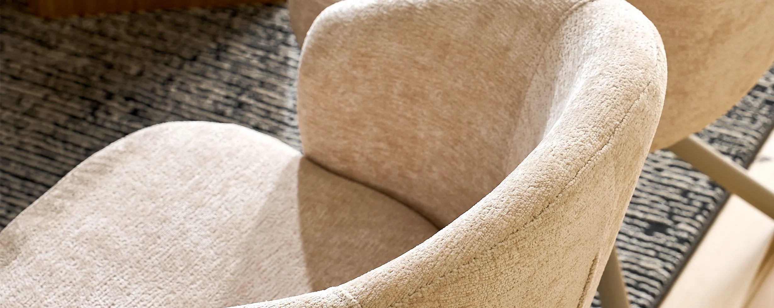 Curved armrest and soft cream chenille fabric of Cleo cream Swivel Chair