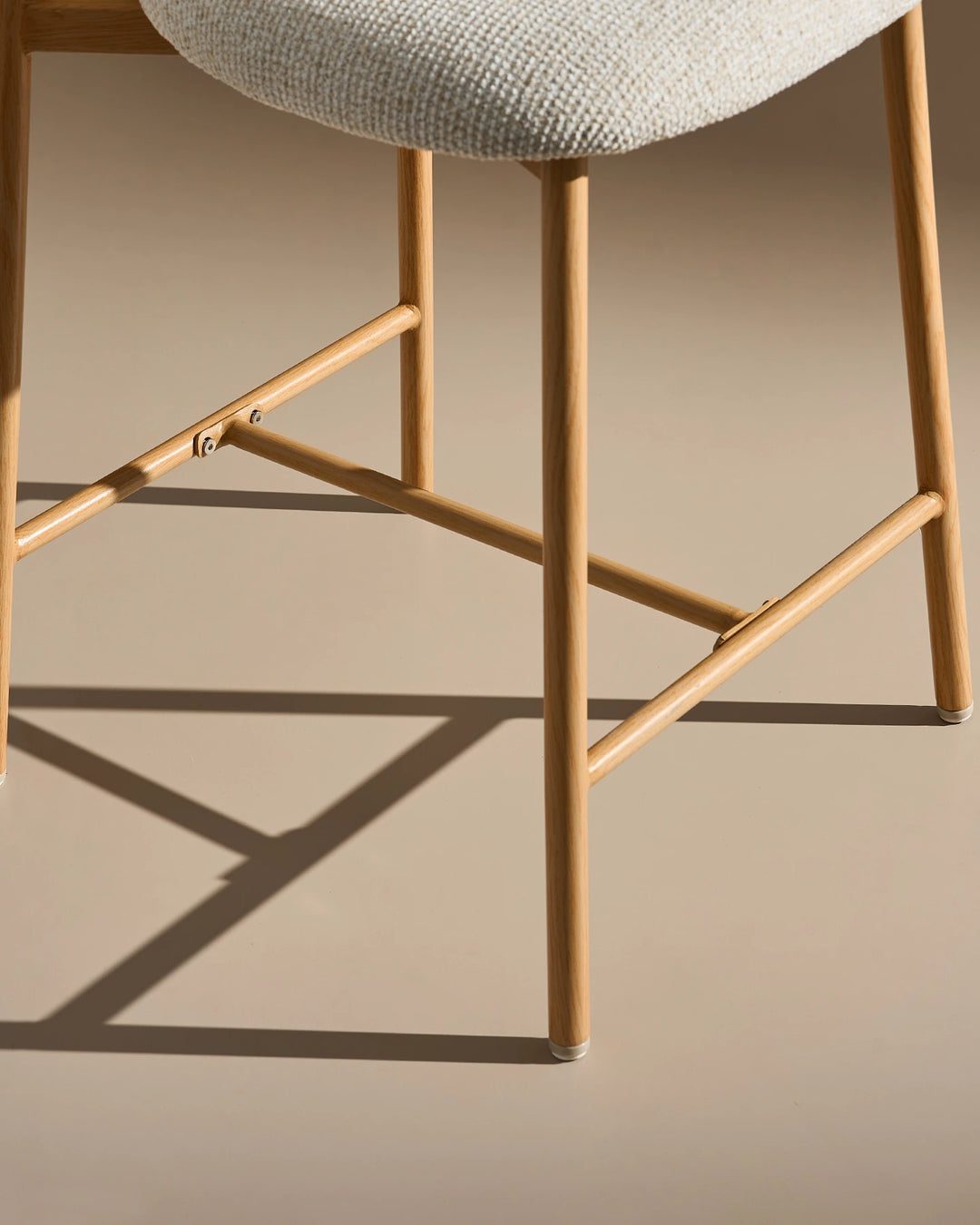 Strong wood-effect legs and footrest detail of Rowan Oak Bar Stool