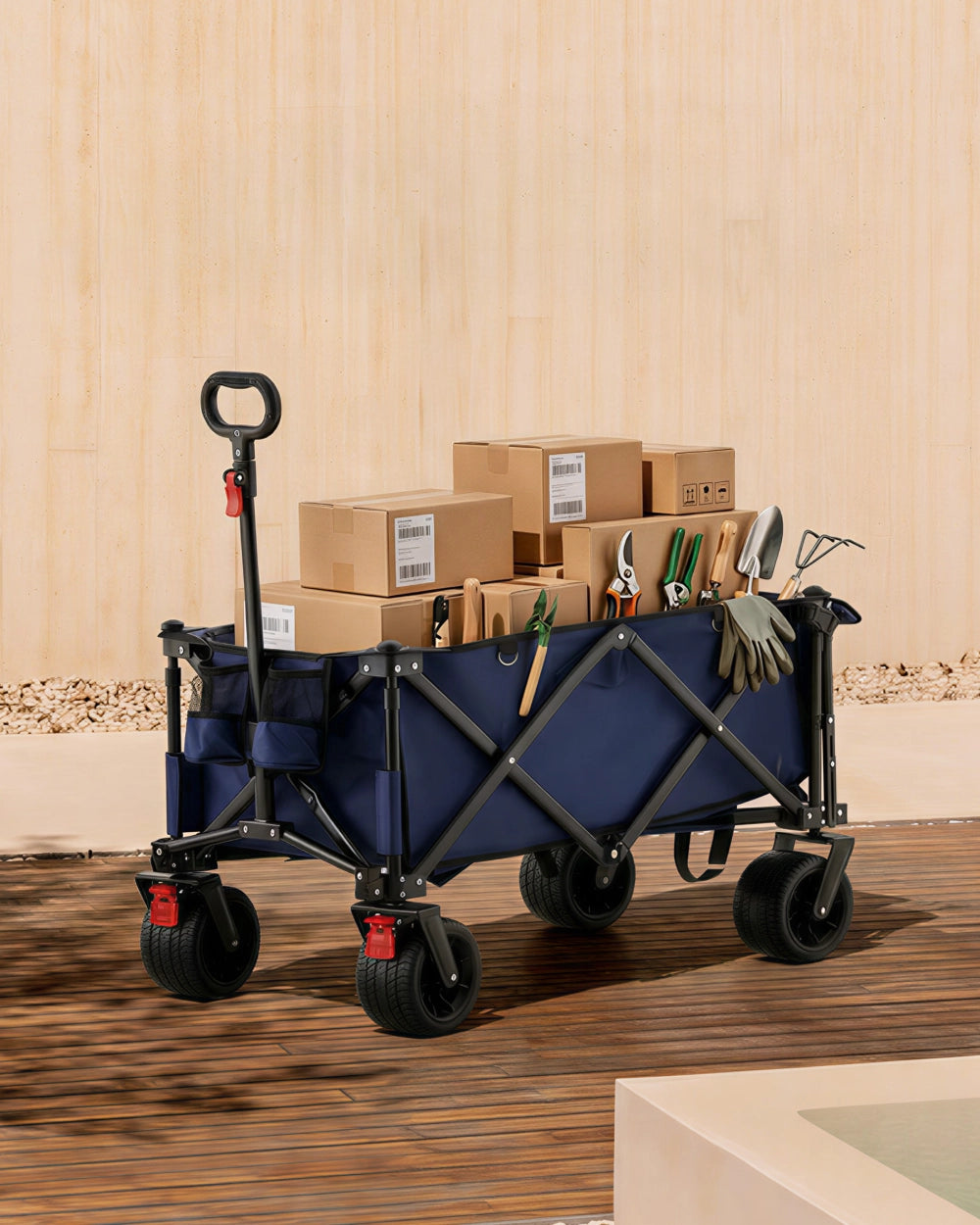 Blue 180L folding outdoor trolley wagon fully loaded with parcels and garden tools, demonstrating its high-volume carrying capability.