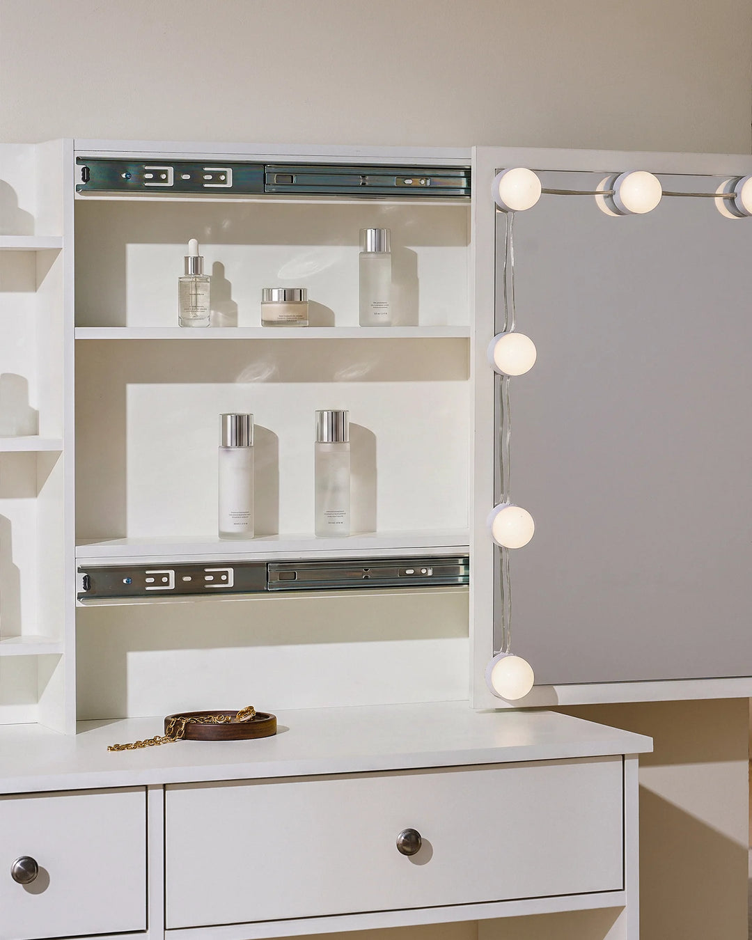Detailed view of the dressing table, showing the compartment behind sliding mirror