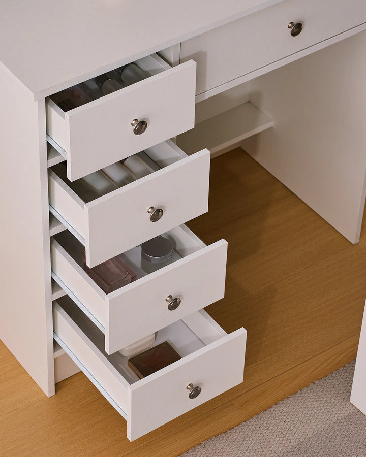 Detailed view of the dressing table showing five drawers, with four open to reveal organised makeup and beauty storage.