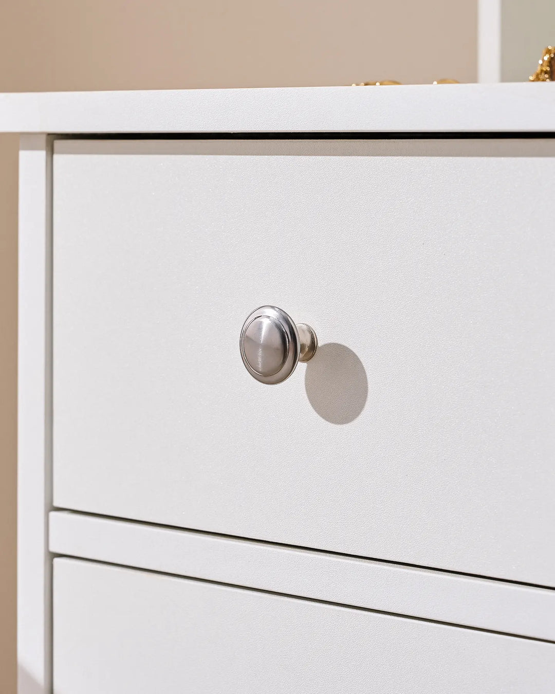 Detailed view of the dressing table showcasing the silver drawer knobs and durable particle board construction.