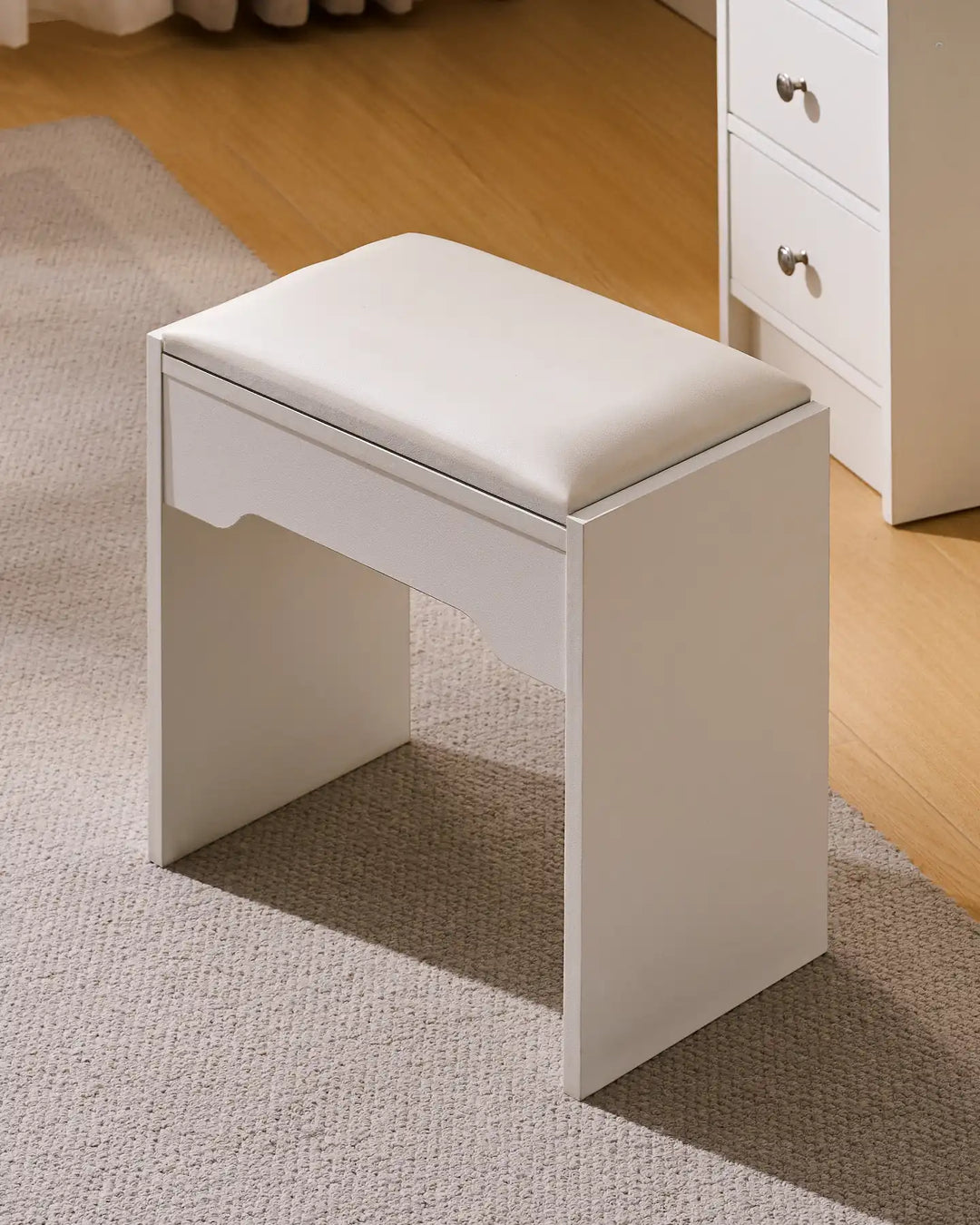 Detailed view of the matching padded stool, highlighting its sturdy construction and cushioned seat.