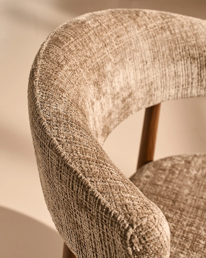 Close-up of the Ansel Mocha Chenille Dining Chair's curved backrest, showcasing the textured chenille upholstery and rounded edges.