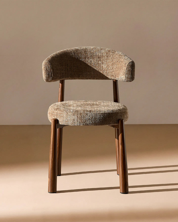Front view of the Ansel Mocha Chenille Dining Chair showing its curved upholstered backrest, rounded seat and slim wooden-effect legs.
