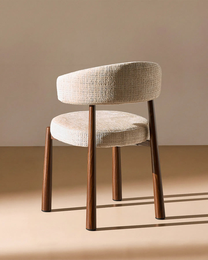 Rear view of the Ansel Oatmeal Chenille Dining Chair showing the curved upholstered backrest and simple, elegant frame.