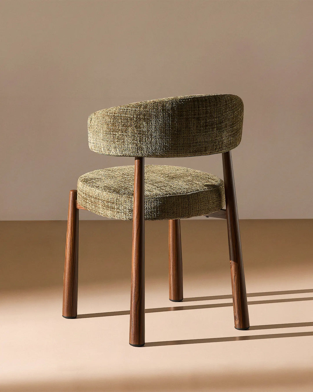 Rear view of the Ansel Olive Green Chenille Dining Chair showing the curved upholstered backrest and simple, elegant frame.