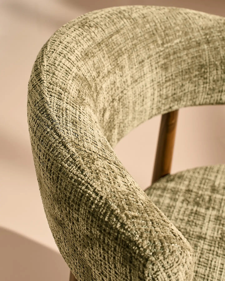 Close-up of the Ansel Olive Green Chenille Dining Chair's curved backrest, showcasing the textured chenille upholstery and rounded edges.