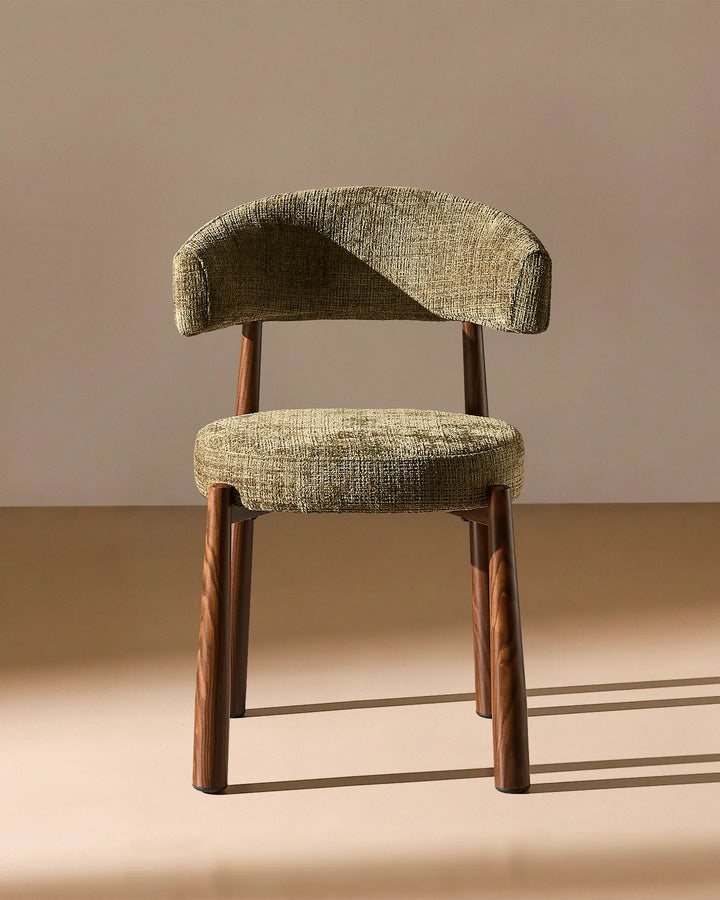 Front view of the Ansel Olive Green Chenille Dining Chair showing its curved upholstered backrest, rounded seat and slim wooden-effect legs.