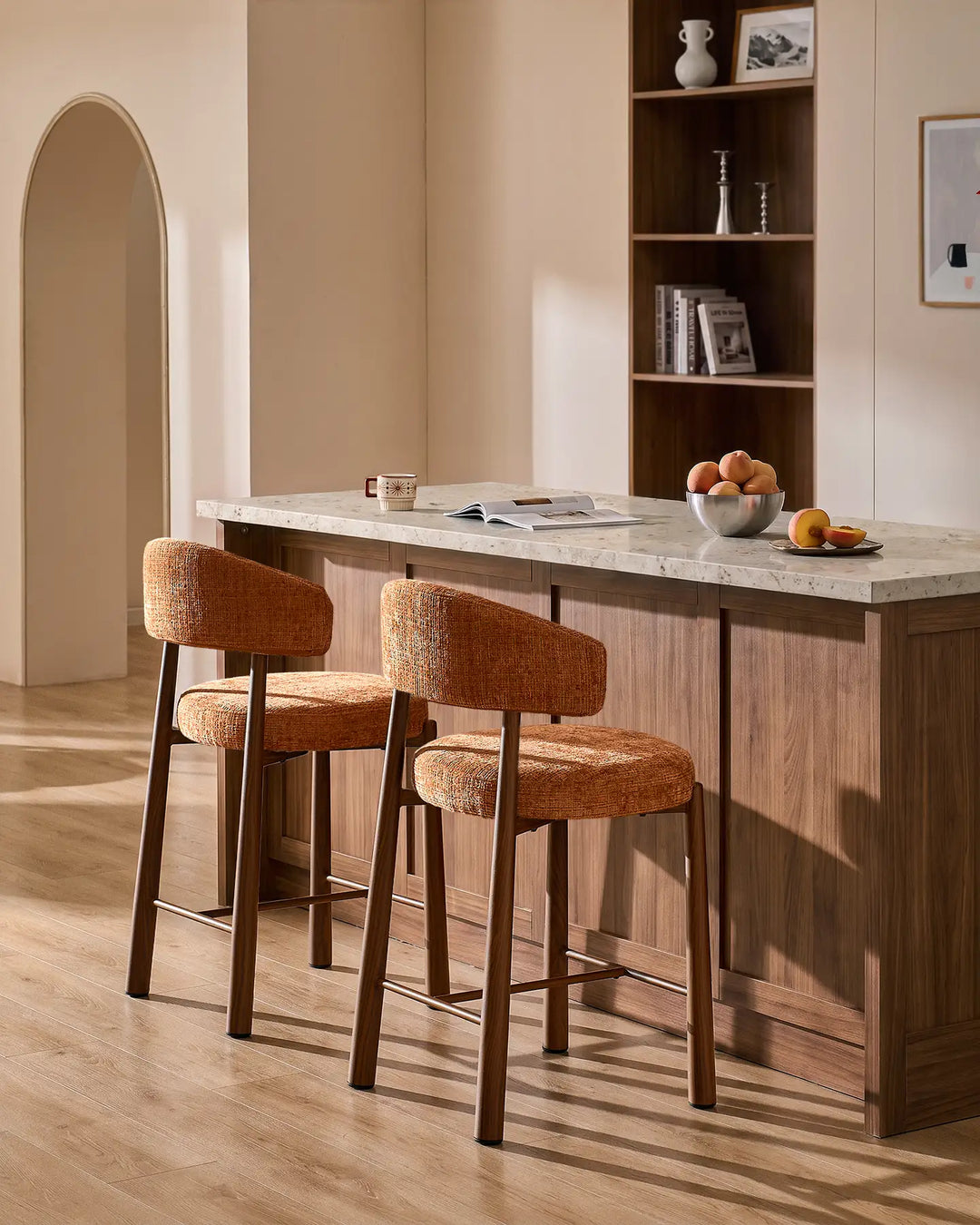 Two Ansel terracotta orange chenille breakfast bar stools with wood-effect metal legs styled at a kitchen island with neutral terrazzo countertop and warm interior decor