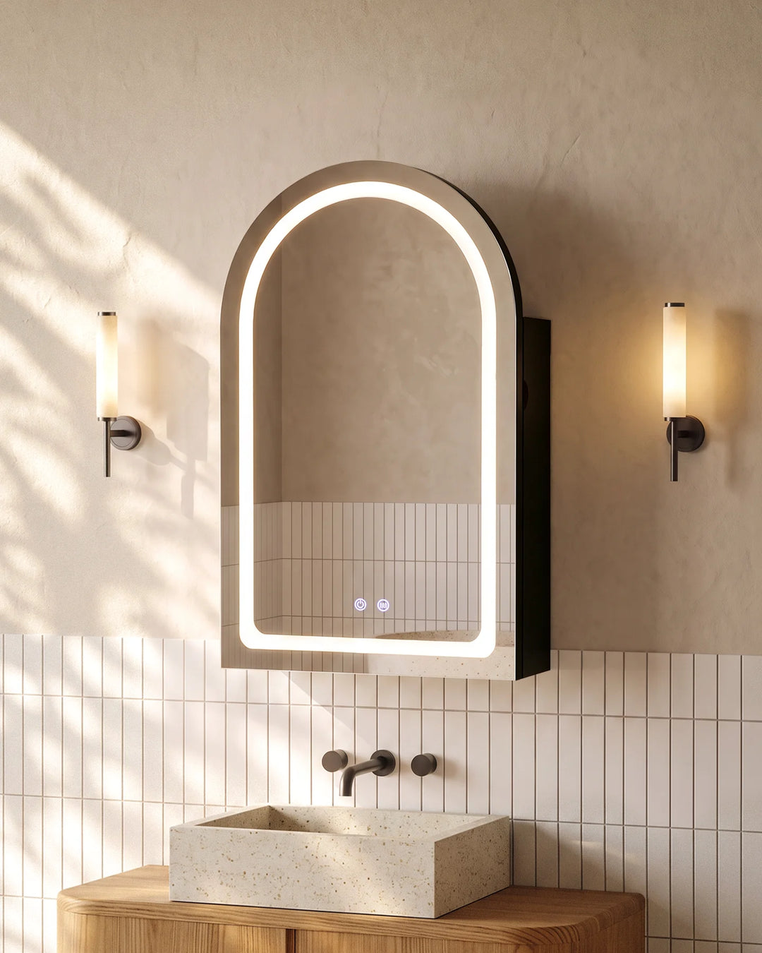 Black Arcadia arched LED mirror cabinet with warm lighting in a modern grey-tiled bathroom.