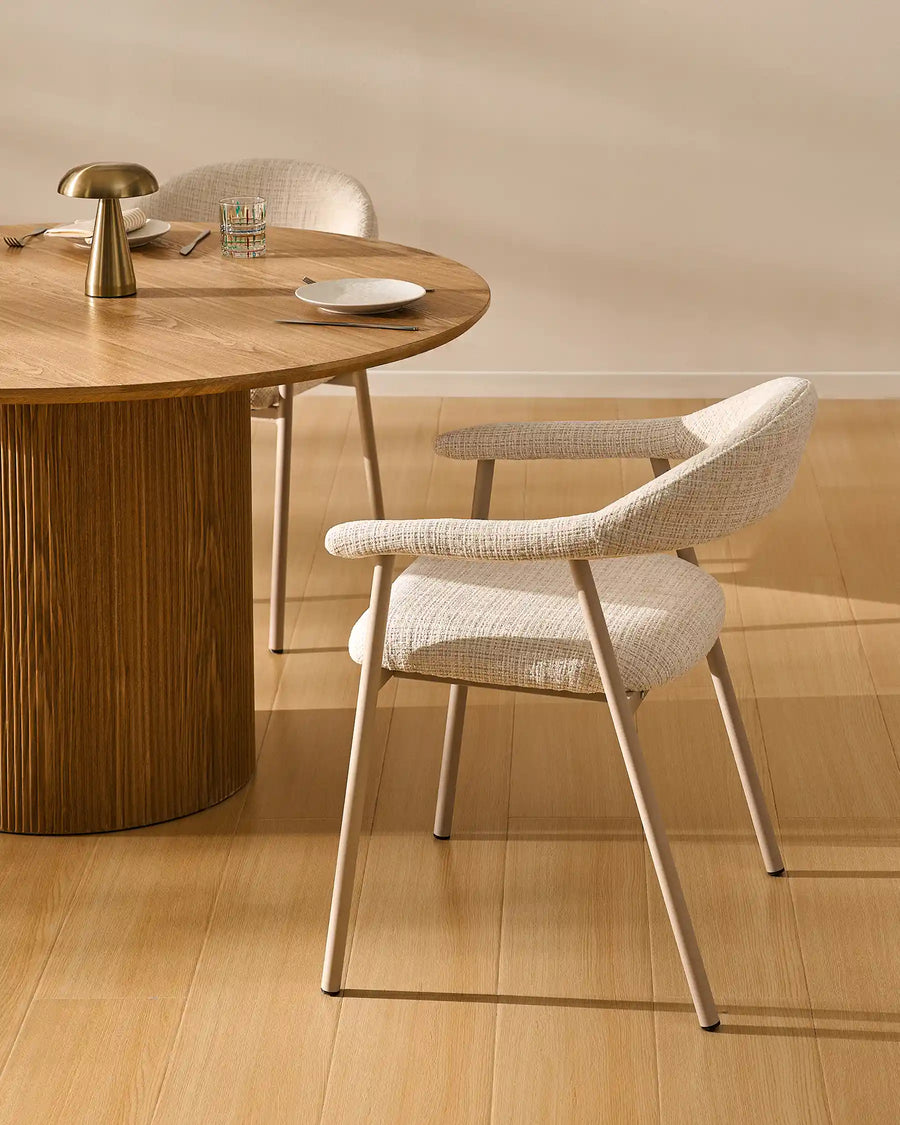 Arlo Dining Chair beside a wooden dining table in a cosy rustic dining room with soft chenille upholstery