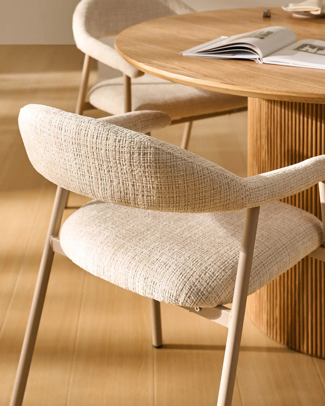 Close-up of the curved backrest on the Arlo Dining Chair with soft chenille upholstery and supportive design