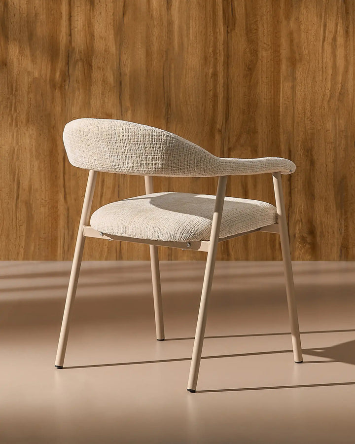 Rear side view of the Arlo Dining Chair highlighting its curved backrest and sturdy metal frame