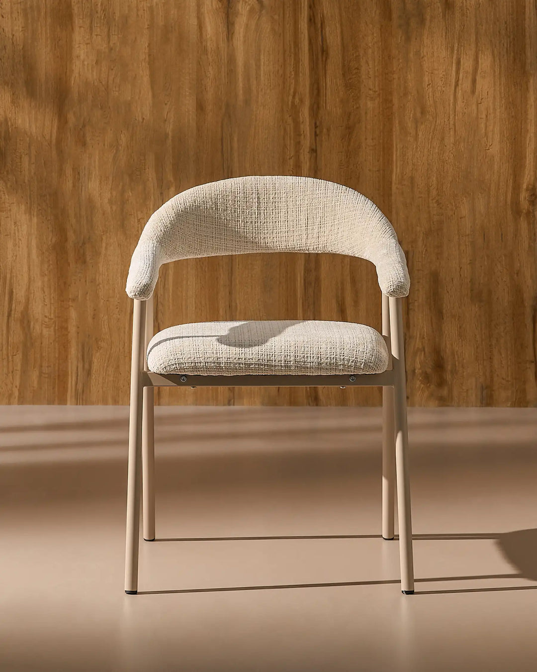 Front view of the Arlo upholstered dining chair with chenille fabric, curved armrests and metal legs