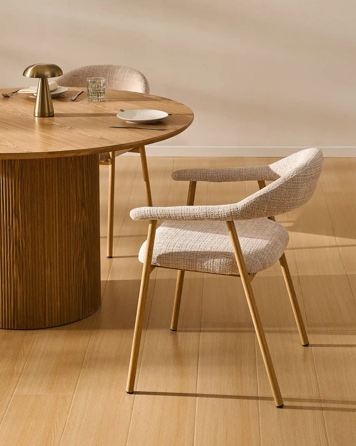 Arlo Dining Chair beside a wooden dining table in a cosy rustic dining room with soft chenille upholstery