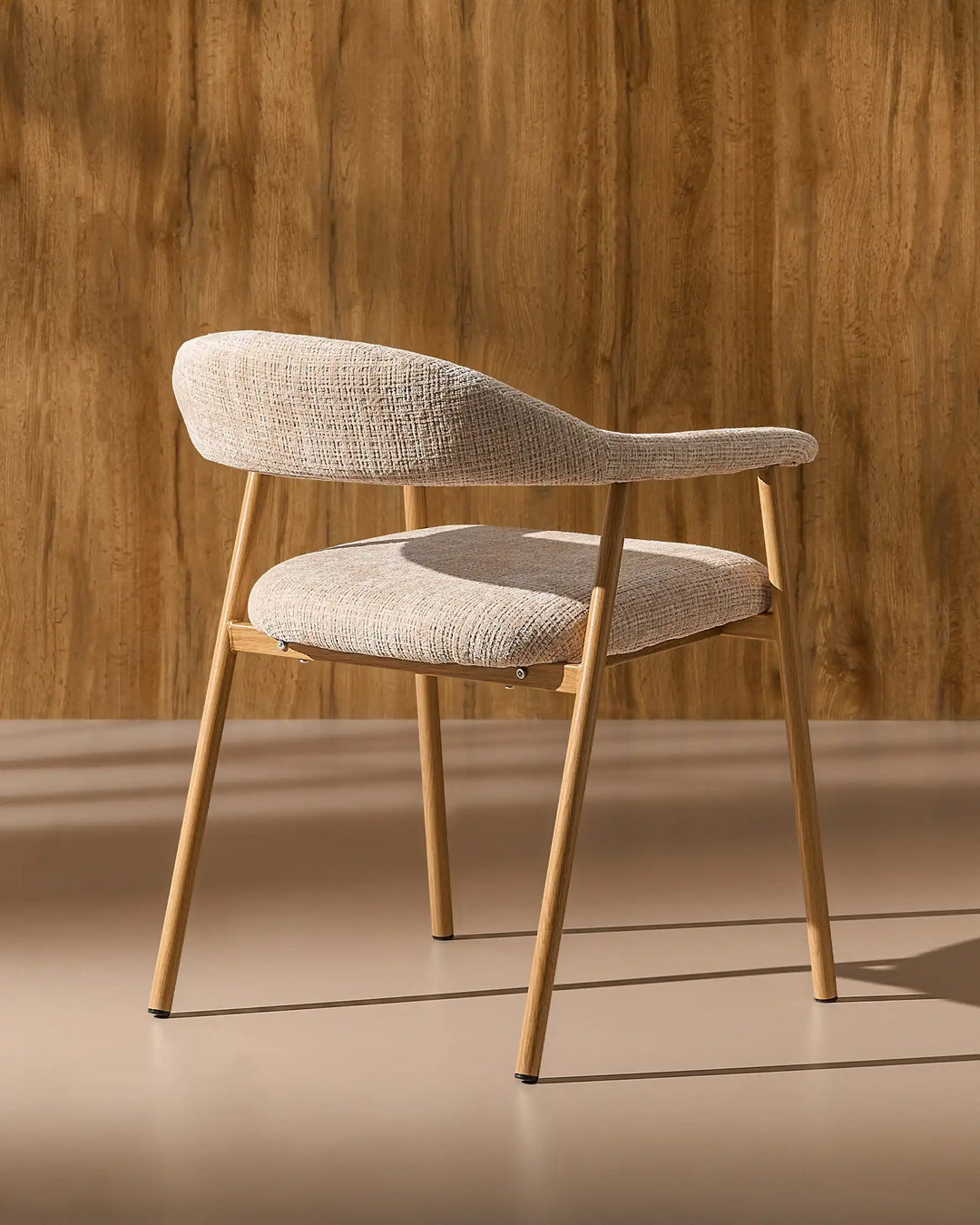 Rear side view of the Arlo Dining Chair highlighting its curved backrest and sturdy metal frame