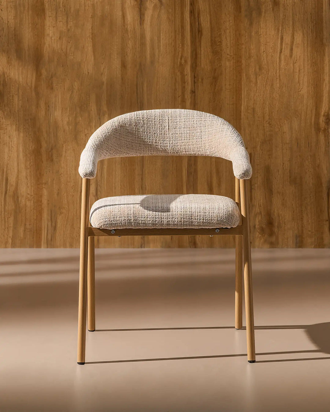 Front view of the Arlo upholstered dining chair with chenille fabric, curved armrests and metal legs
