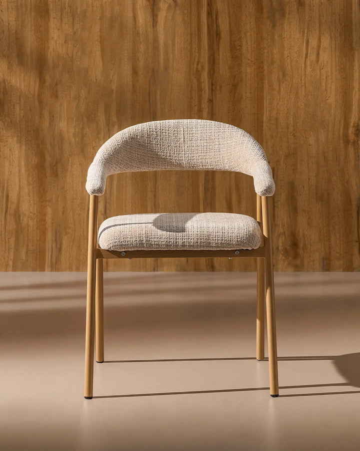 Front view of the Arlo upholstered dining chair with chenille fabric, curved armrests and metal legs