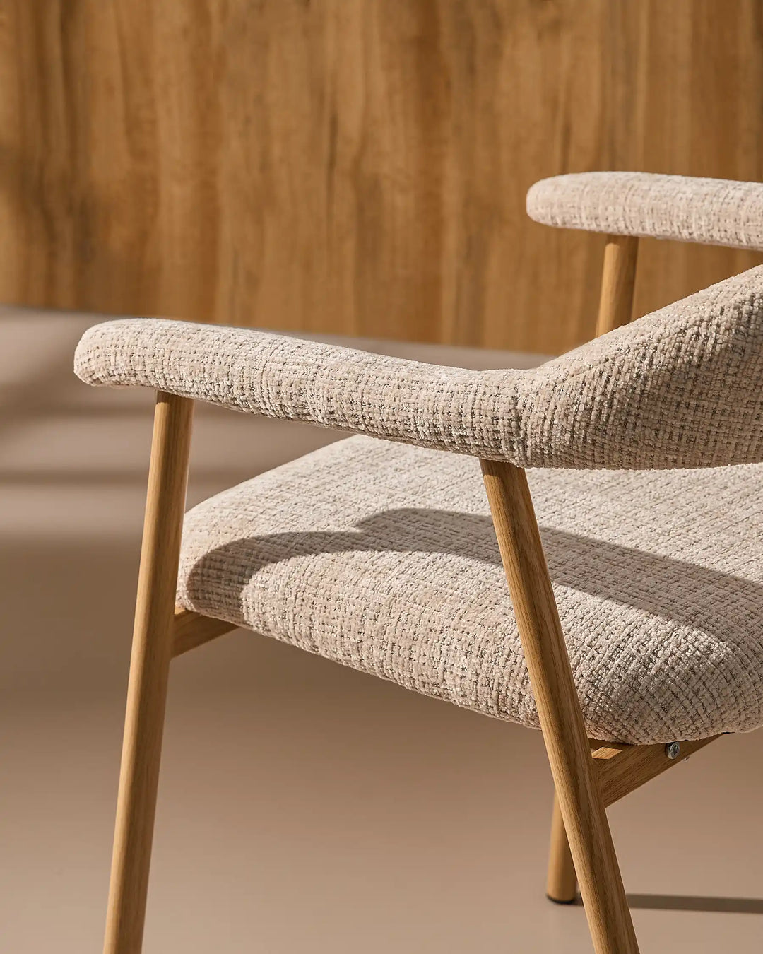 Close-up of the sculpted armrests on the Arlo Dining Chair, designed for relaxed everyday dining comfort