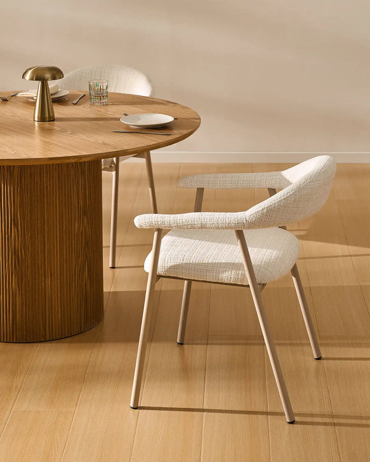 Arlo Dining Chair beside a wooden dining table in a cosy rustic dining room with soft chenille upholstery