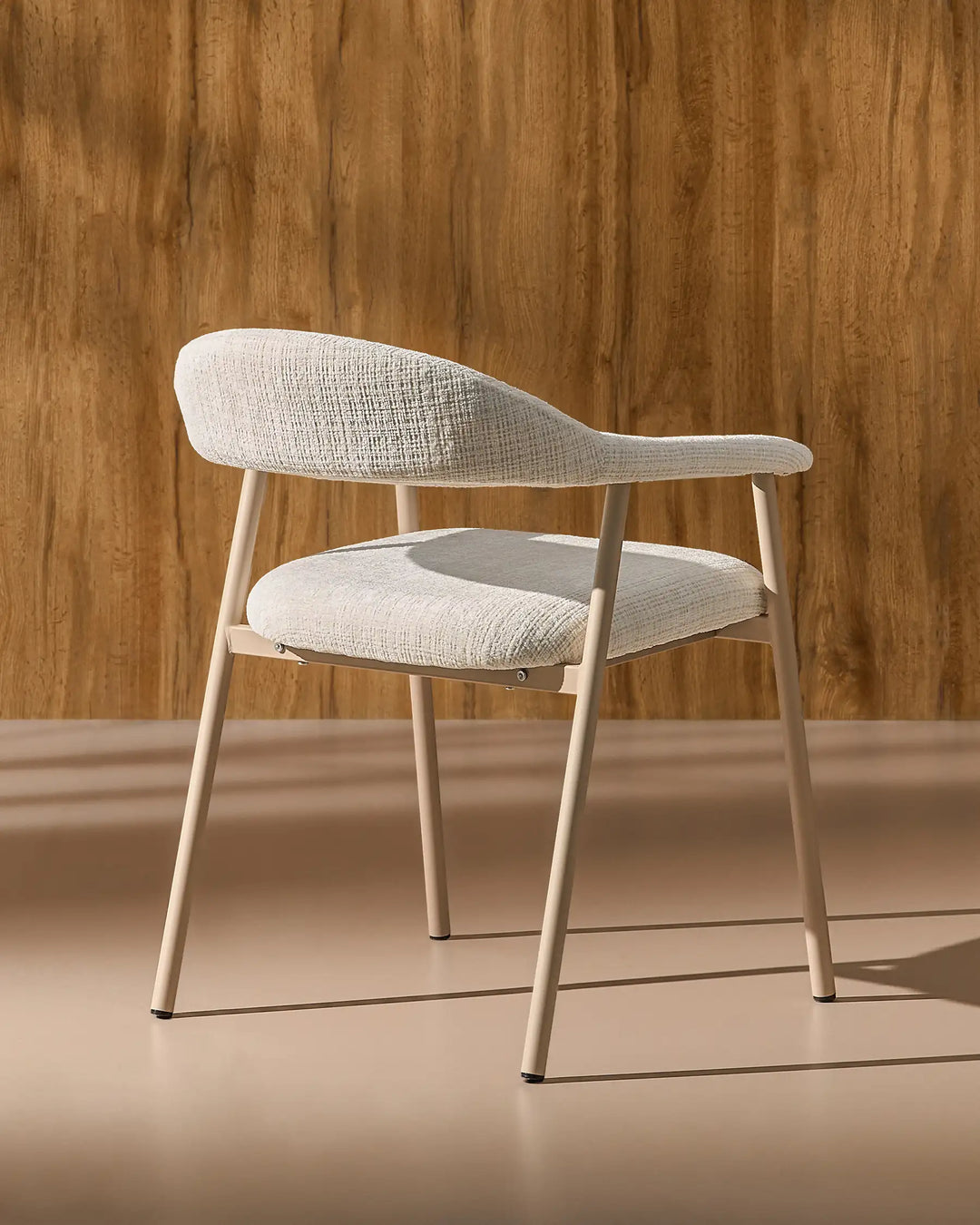 Rear side view of the Arlo Dining Chair highlighting its curved backrest and sturdy metal frame