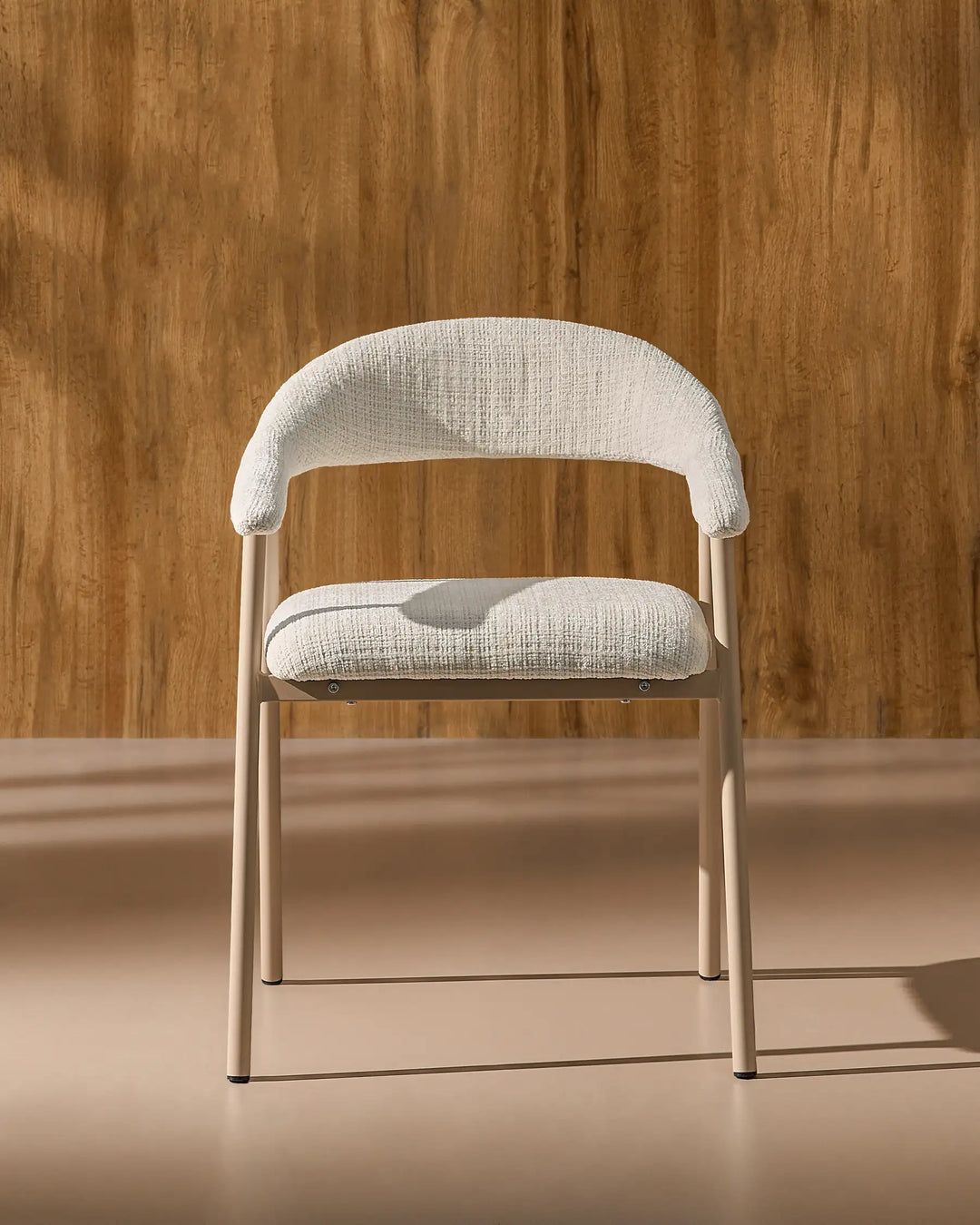 Front view of the Arlo upholstered dining chair with chenille fabric, curved armrests and metal legs