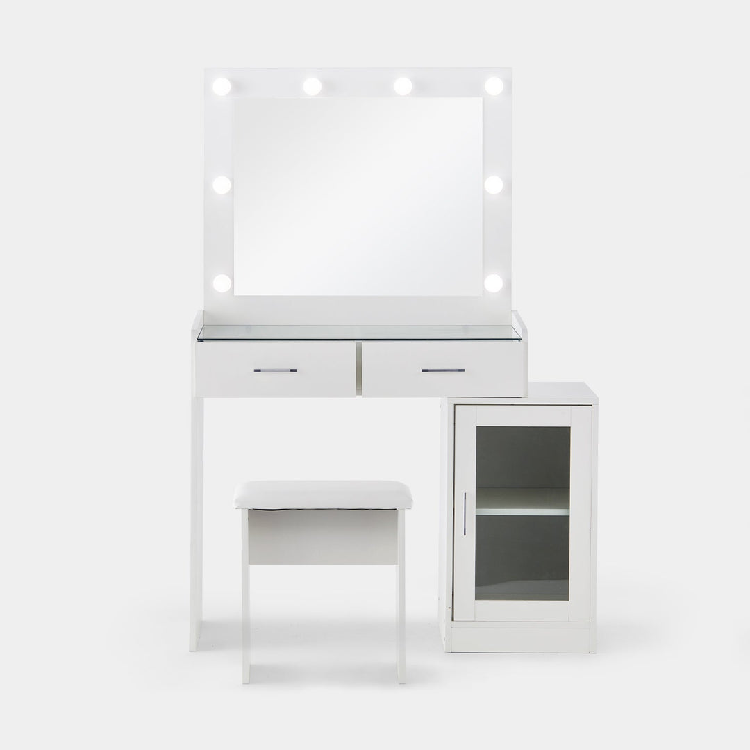 The front view of the white dressing table set, featuring a glass tabletop, a mirror, 8 bulbs, 2 drawers, a cabinet with a glass door, and a stool,  in a white background.