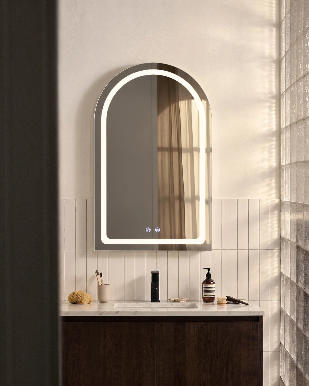 Front view of black Arcadia arched LED bathroom mirror cabinet against a contemporary wall.