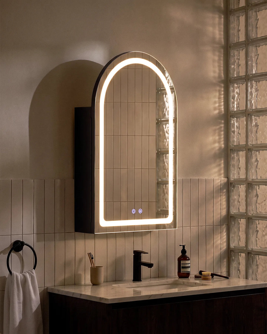 Black Arcadia arched LED bathroom mirror cabinet installed near a glass feature wall.
