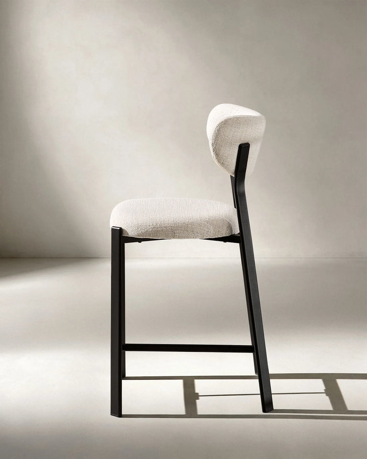 Side profile of Bramley Black Oak Bar Stool with curved backrest and black oak wood effect legs