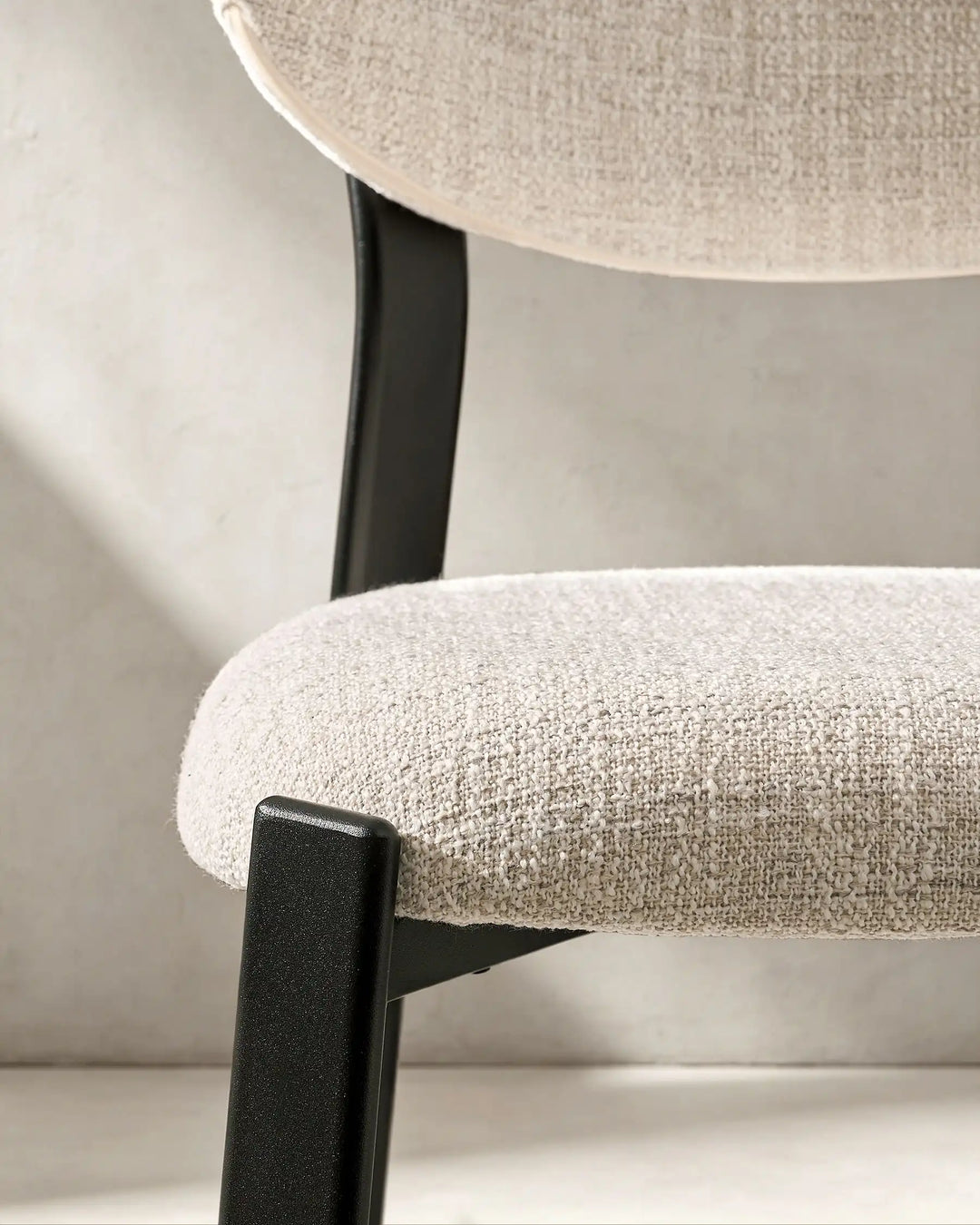 Thick upholstered seat detail of Bramley Black Oak Bar Stool with supportive linen fabric cushioning