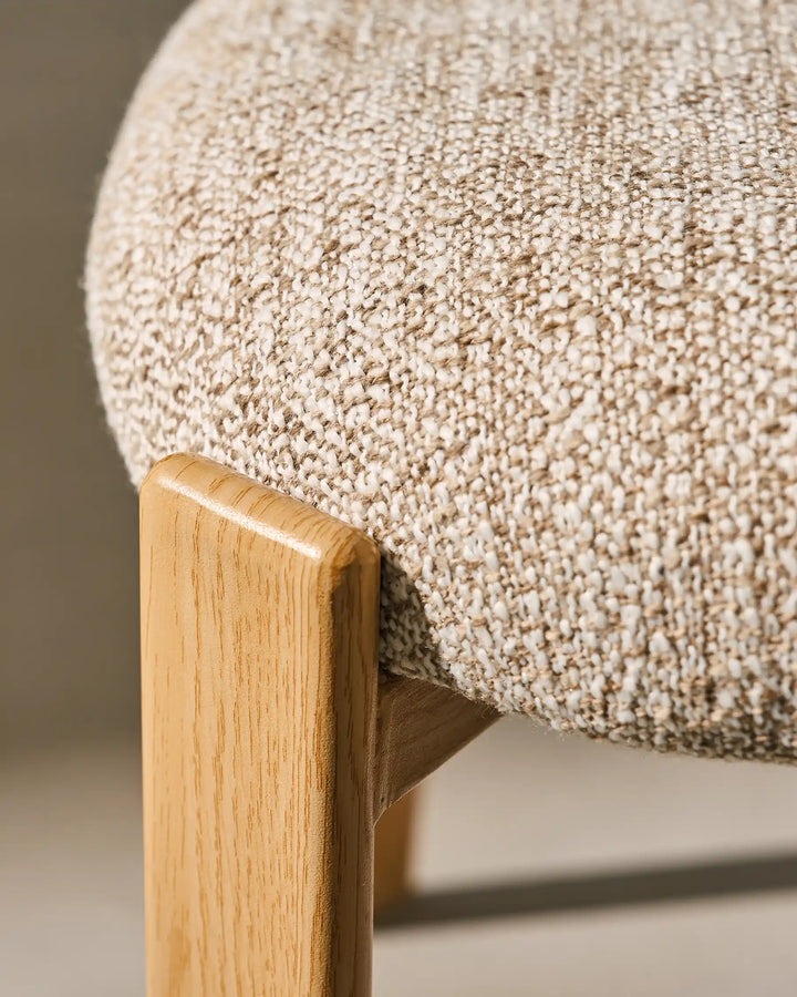 Side detail of Bramley Rustic Linen Dining Chair showing natural wood grain chair legs