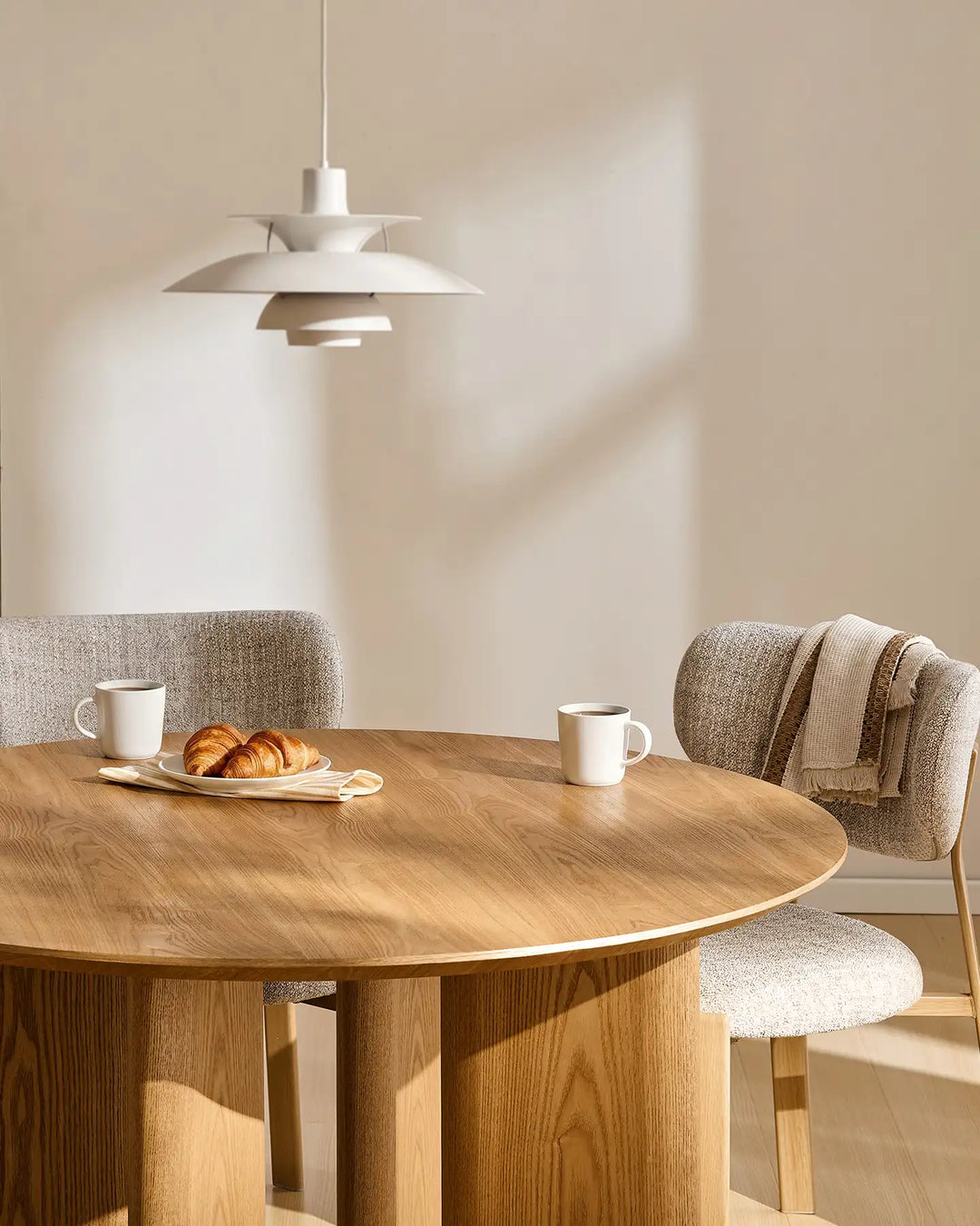 Bramley oak dining table styled for breakfast with tableware and fresh flowers in a cosy dining space