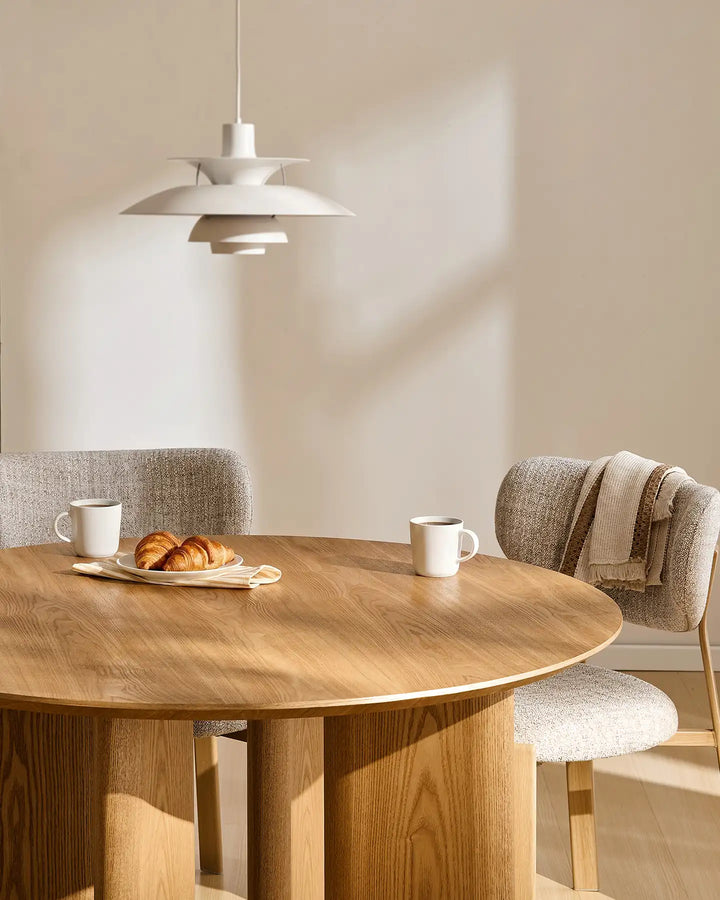 Bramley oak dining table styled for breakfast with tableware and fresh flowers in a cosy dining space