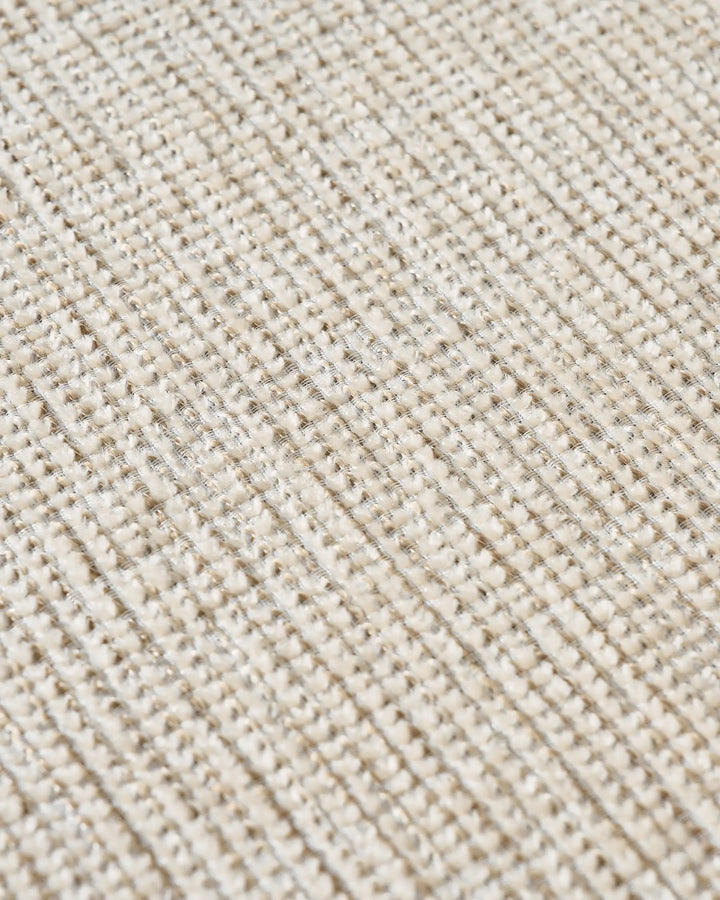 Close-up of ivory and off white chenille upholstery showing the fabric texture and natural woven finish