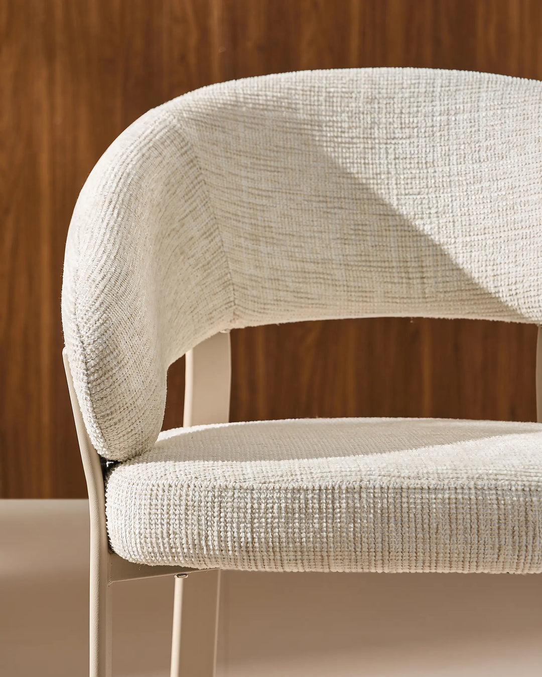 Front view of Bramley ivory and off white dining armchair showing curved armrests and upholstered seat details
