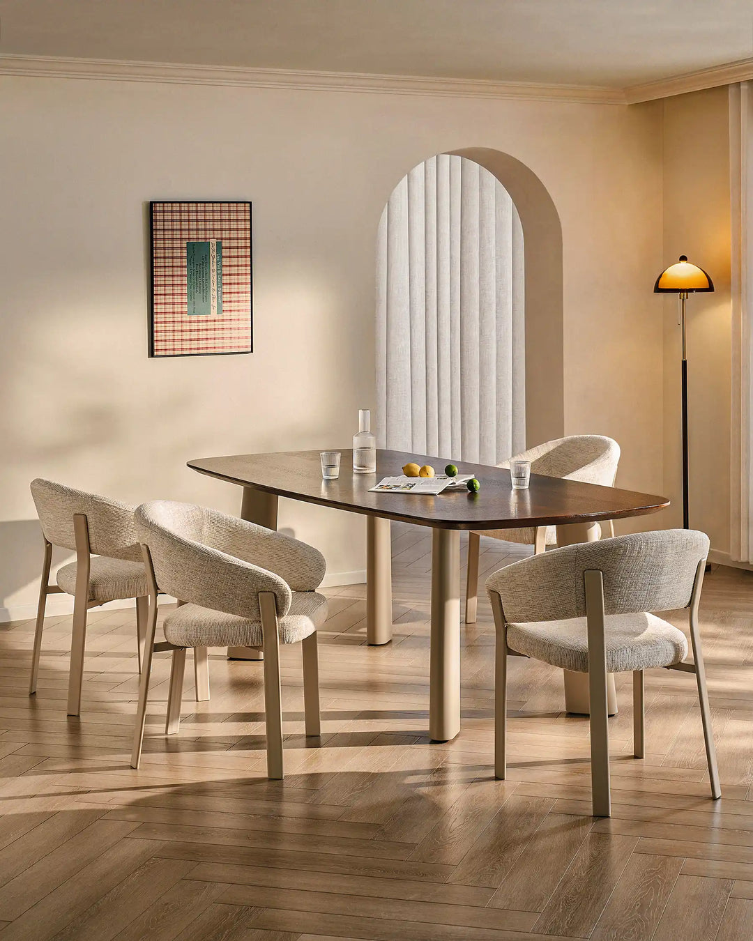 Four Bramley ivory and off white dining armchairs surrounding a dining table in a warm organic dining space