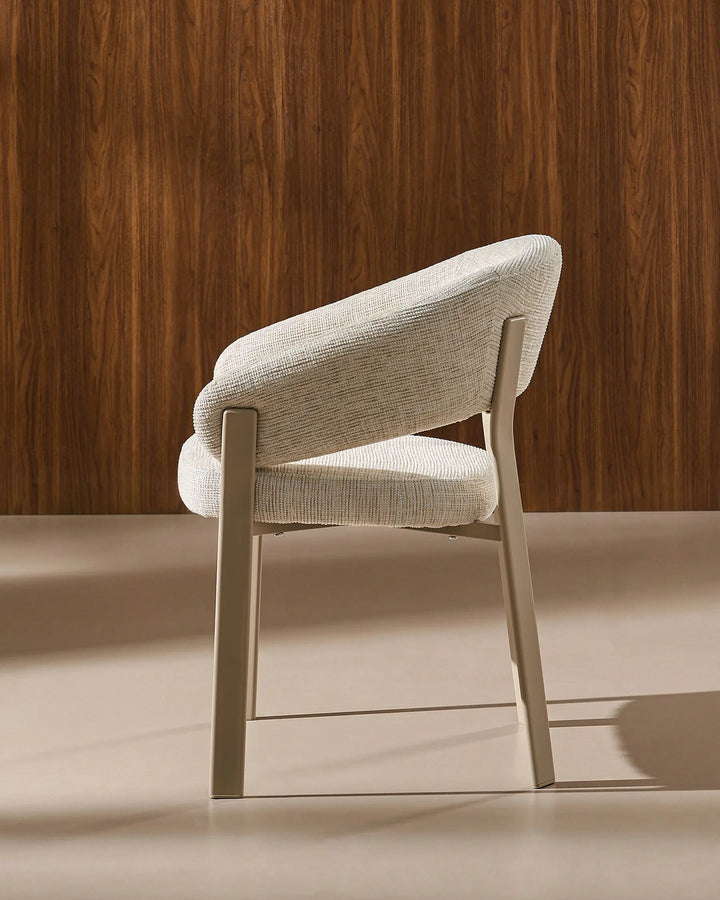 Side view of Bramley ivory and off white rustic dining chair showing curved silhouette and armrests