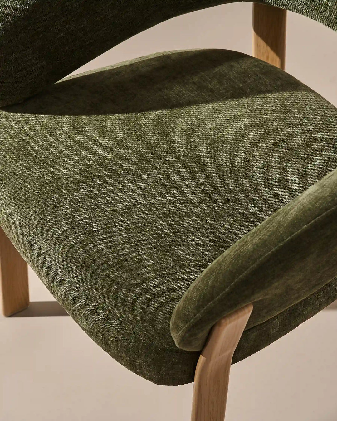 Top view of Bramley moss green and oak upholstered dining armchair with soft textured chenille seat