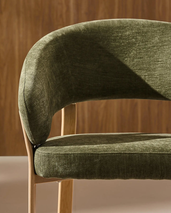 Front view of Bramley moss green and oak dining armchair showing curved armrests and upholstered seat details