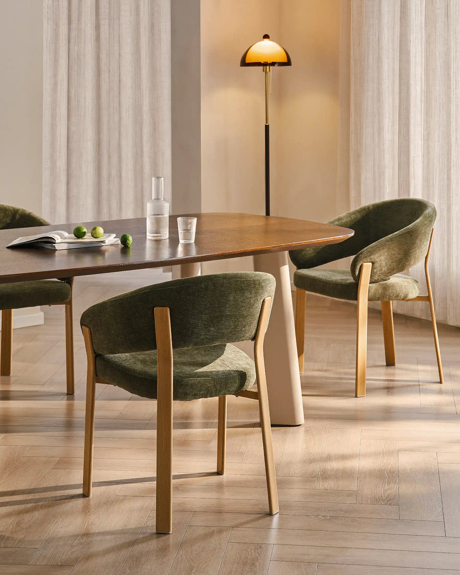 Two Bramley moss green and oak dining armchairs placed at a dining table in an organic farmhouse dining room