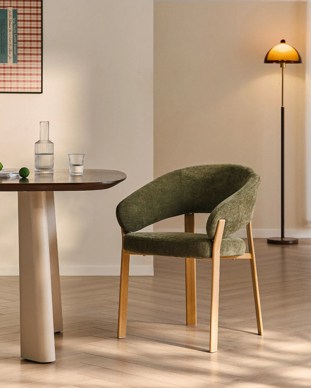 Bramley moss green and oak upholstered dining armchair beside a rustic dining table in a relaxed farmhouse interior