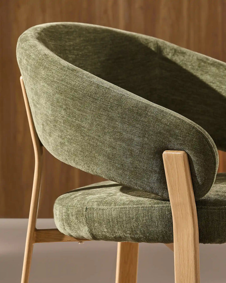 Side view of Bramley moss green and oak dining chair displaying curved arms, supportive backrest and solid wood legs