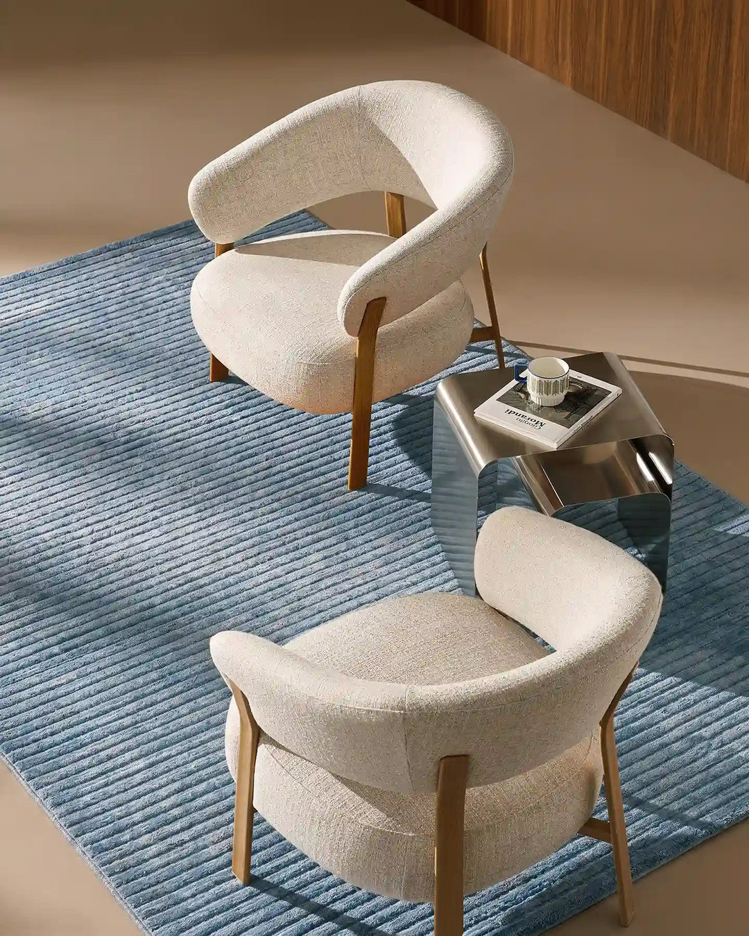 Two Bramley Accent Chairs in oak facing each other in a modern living room, top view