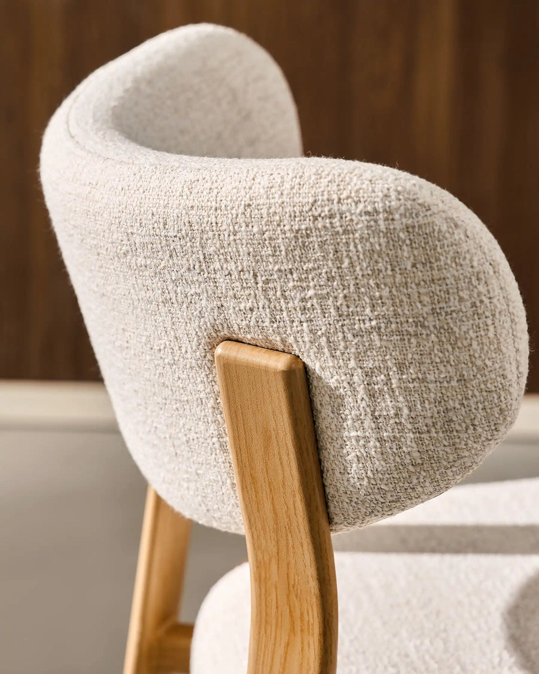 Curved backrest detail of Bramley Oak Bar Stool showing textured linen fabric upholstery and modern rustic craftsmanship