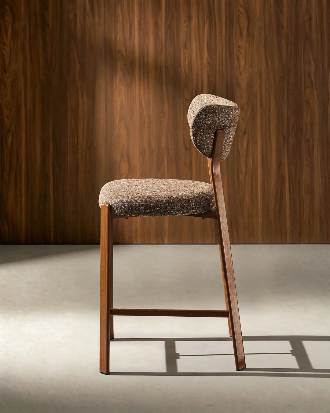 Side view of Bramley Walnut Bar Stool with curved backrest and walnut wood effect legs