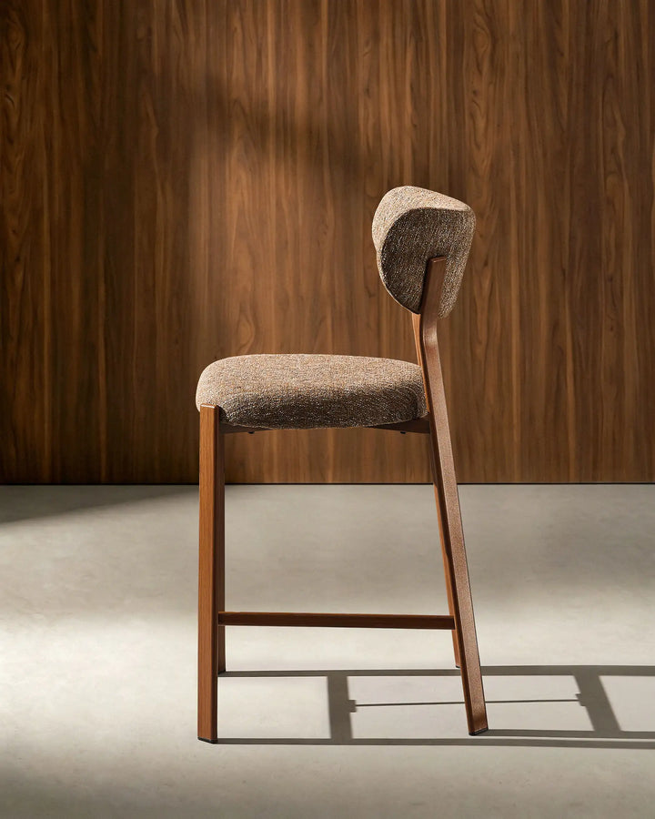 Side view of Bramley Walnut Bar Stool with curved backrest and walnut wood effect legs