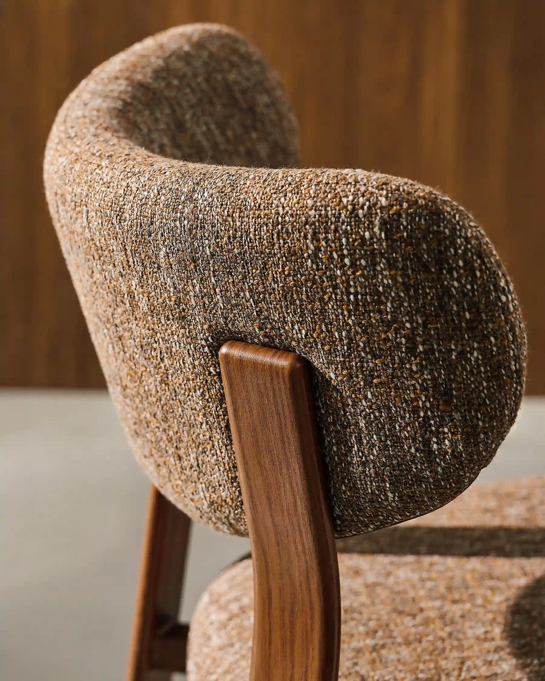 Curved backrest detail of Bramley Walnut Bar Stool featuring textured linen fabric upholstery