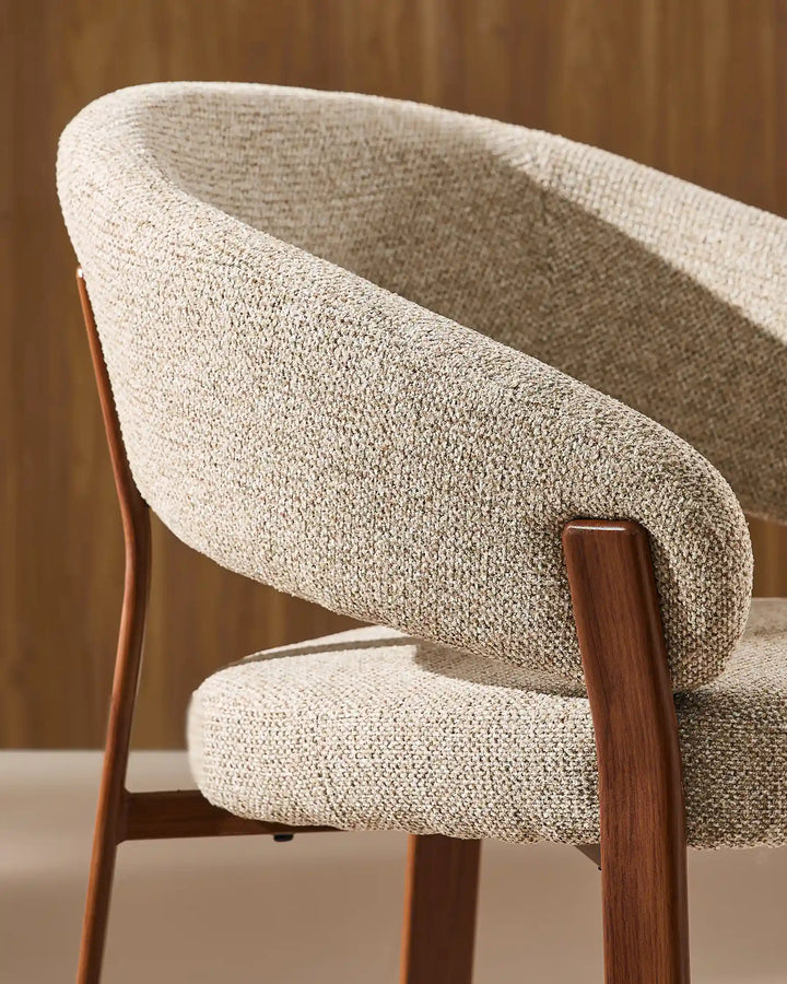 Side view of Bramley warm taupe and walnut dining chair displaying curved arms, supportive backrest and solid wood legs